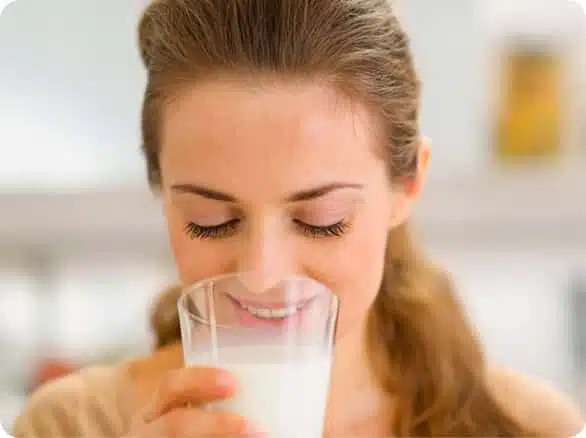 אישה שותה כוס חלב